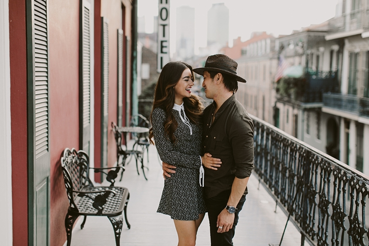 Stylish couple standing on balcony in New Orleans