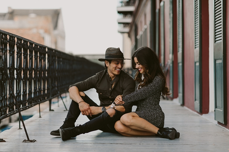 Trendy couple sitting on balcony in New Orleans