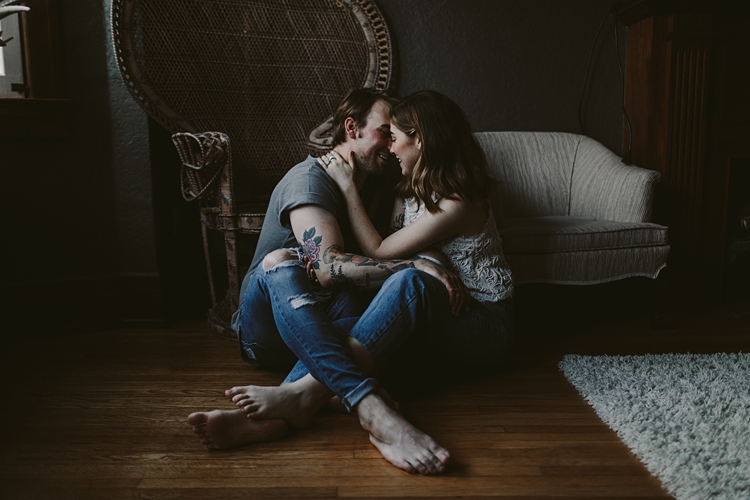 Couple embracing on wooden floor