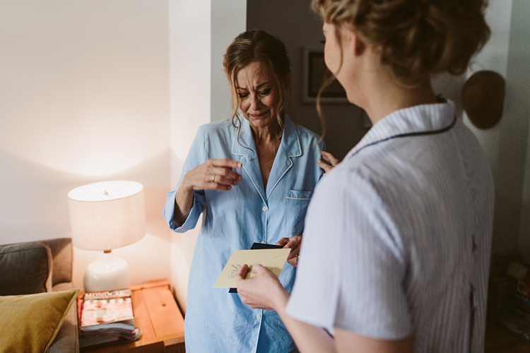 Emotional mother crying after seeing bride in the morning