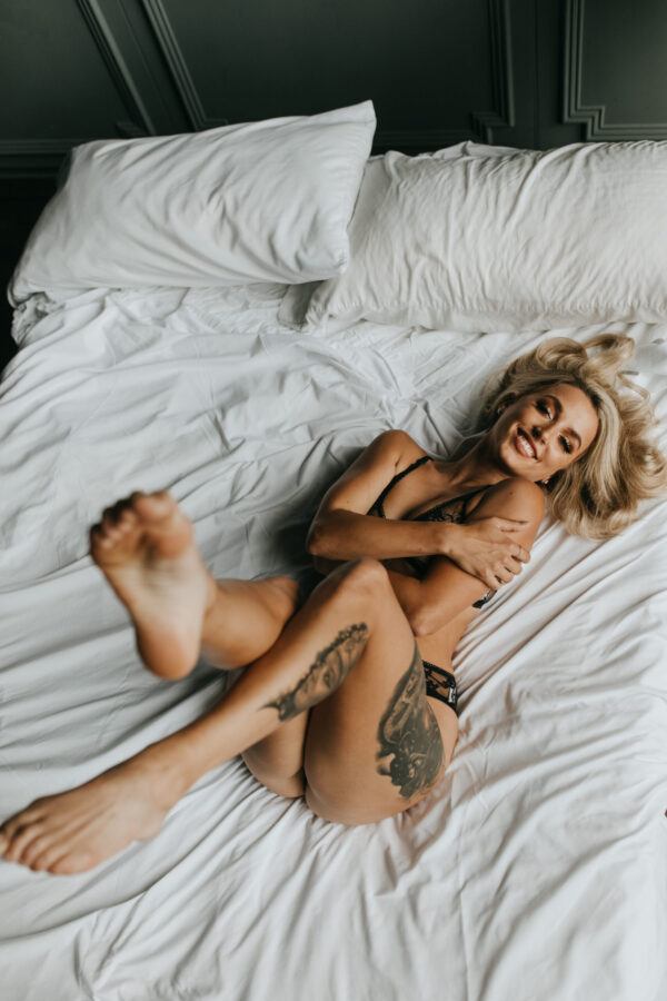 woman in lingerie rolling in bed